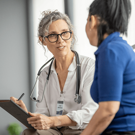 Healthcare provider consulting with a patient to deliver coordinated care
