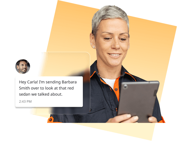 Auto dealership employee using a tablet with a customer text message notification