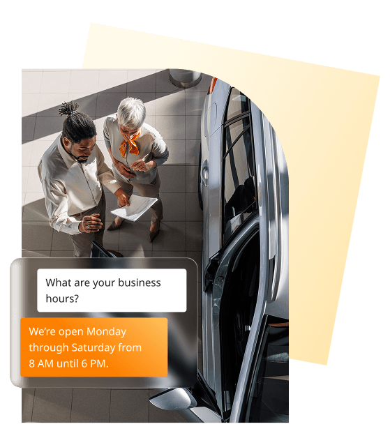 Dealership employees reviewing vehicle information with a customer chat message