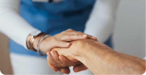 Care team member holding a patient's hand